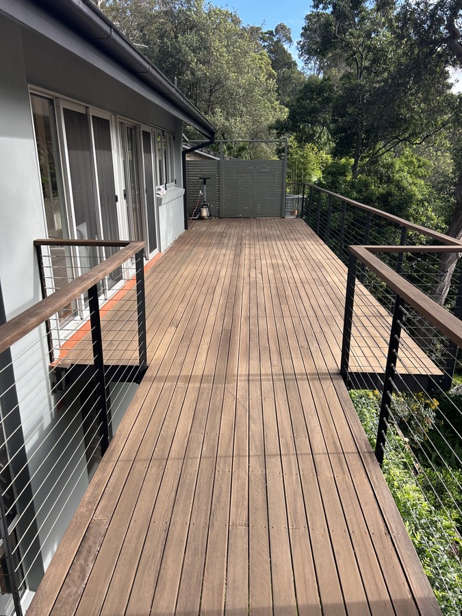 Wide sunny deck with cable railings — Northern Beaches